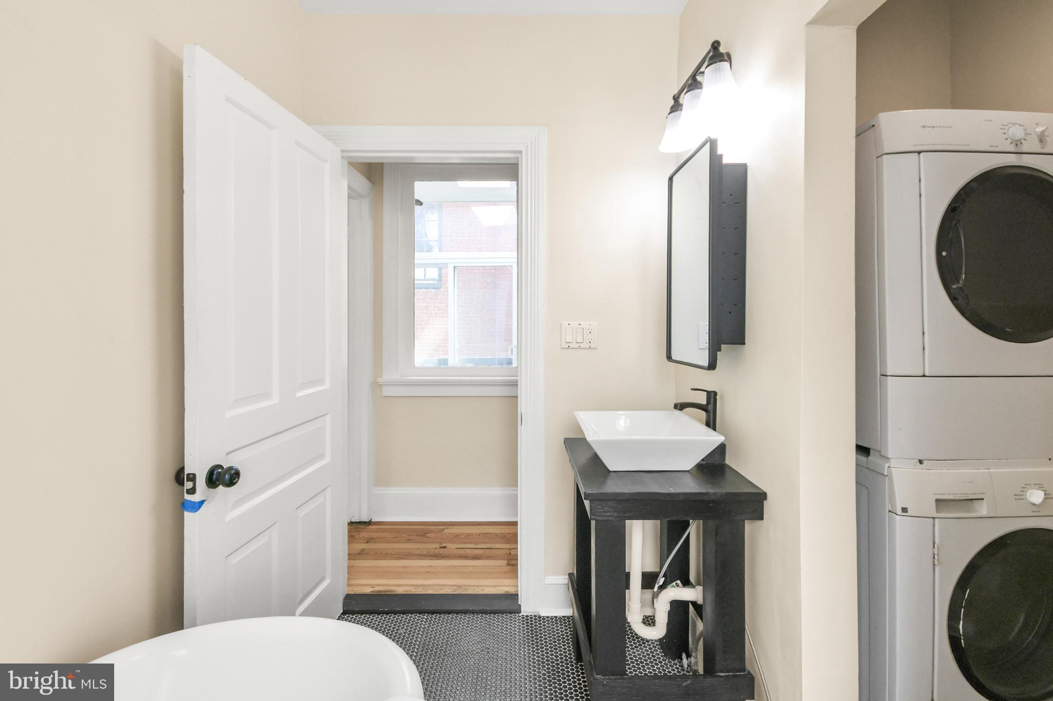 23 West 4th Street Frederick, MD 21701 - Photo 79 of 105 a bathroom with a sink a toilet and a mirror
