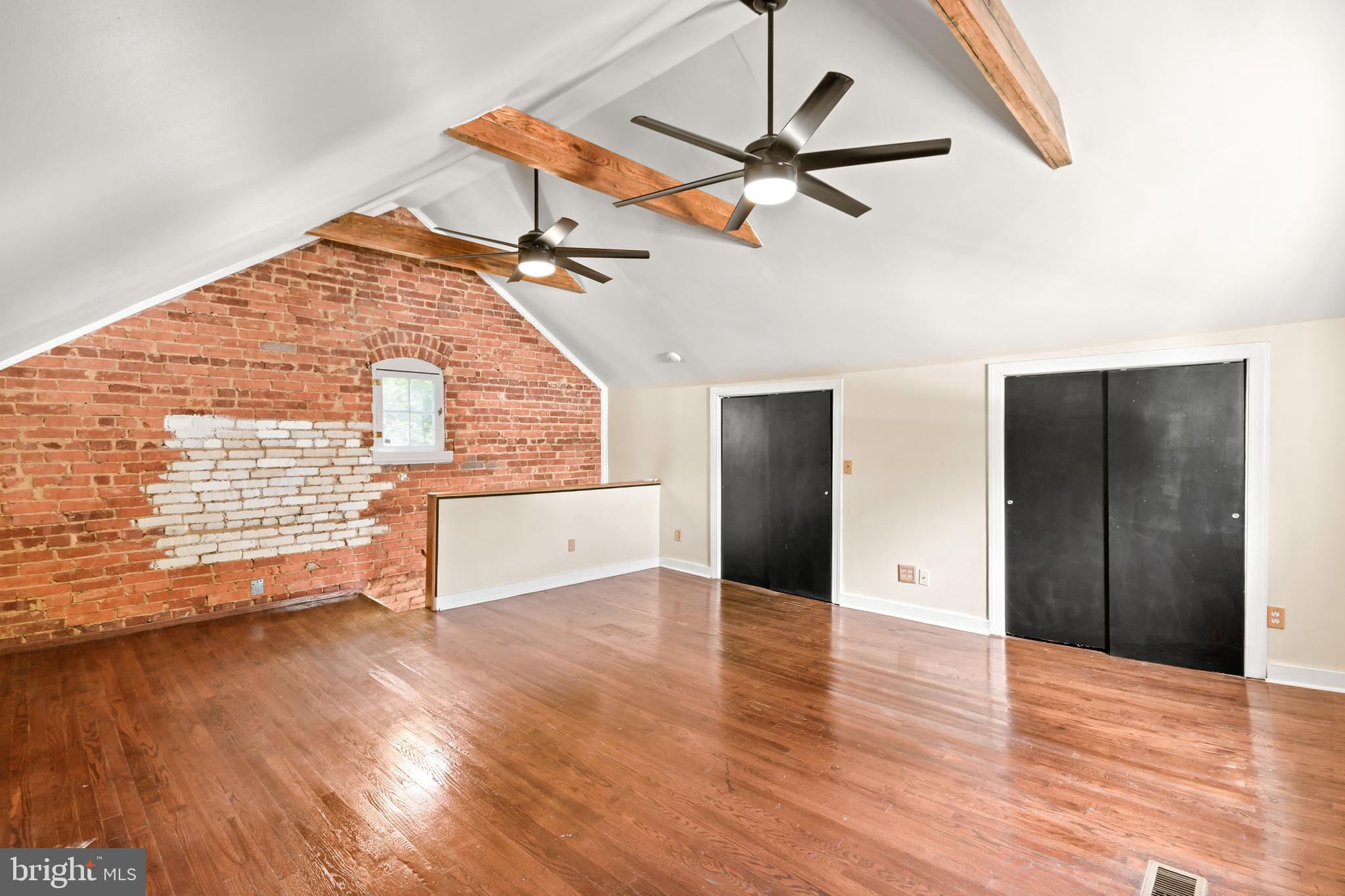 23 West 4th Street Frederick, MD 21701 - Photo 83 of 105 an empty room with wooden floor fan and windows
