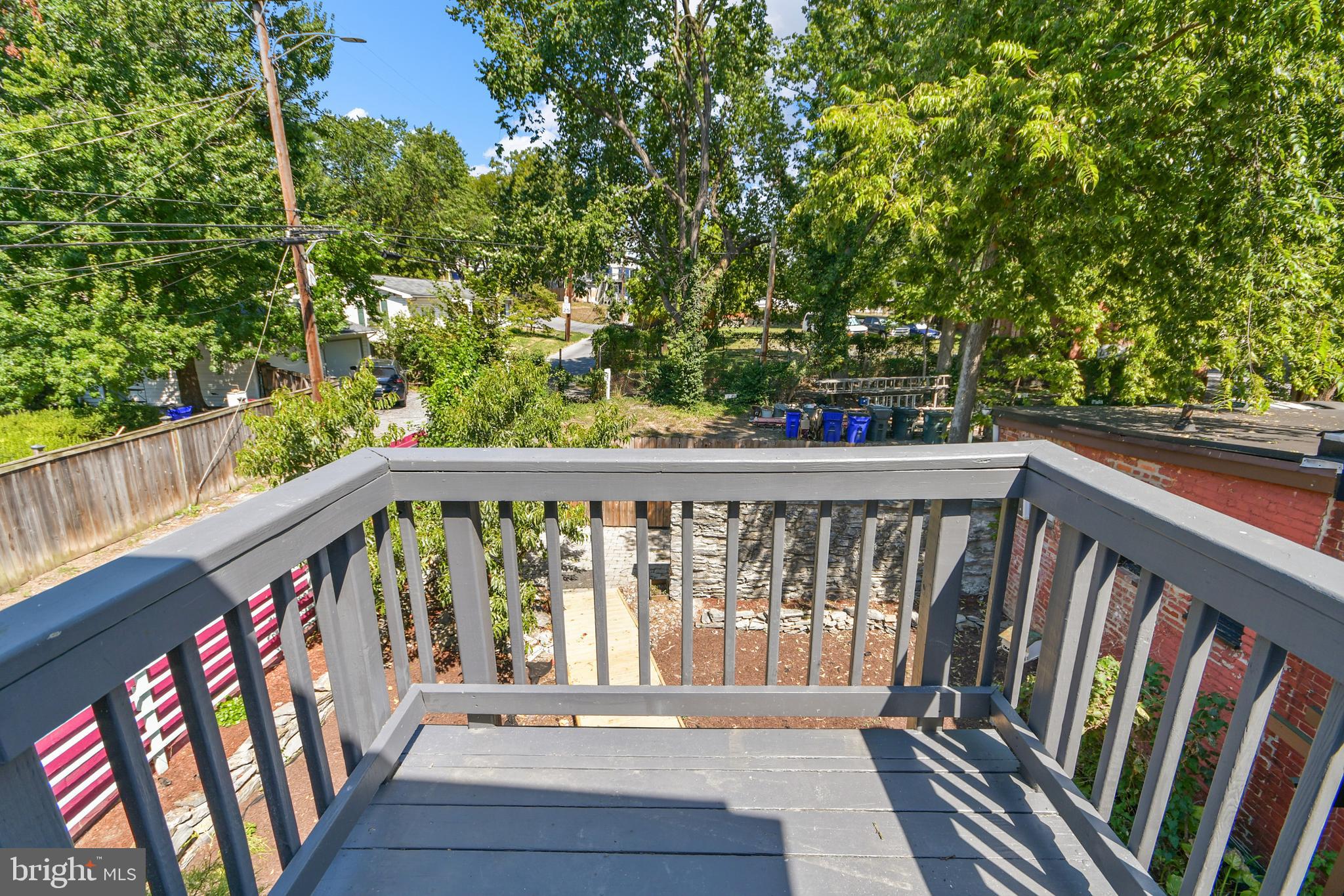 23 West 4th Street Frederick, MD 21701 - Photo 93 of 105 a balcony with wooden floor and trees in the back