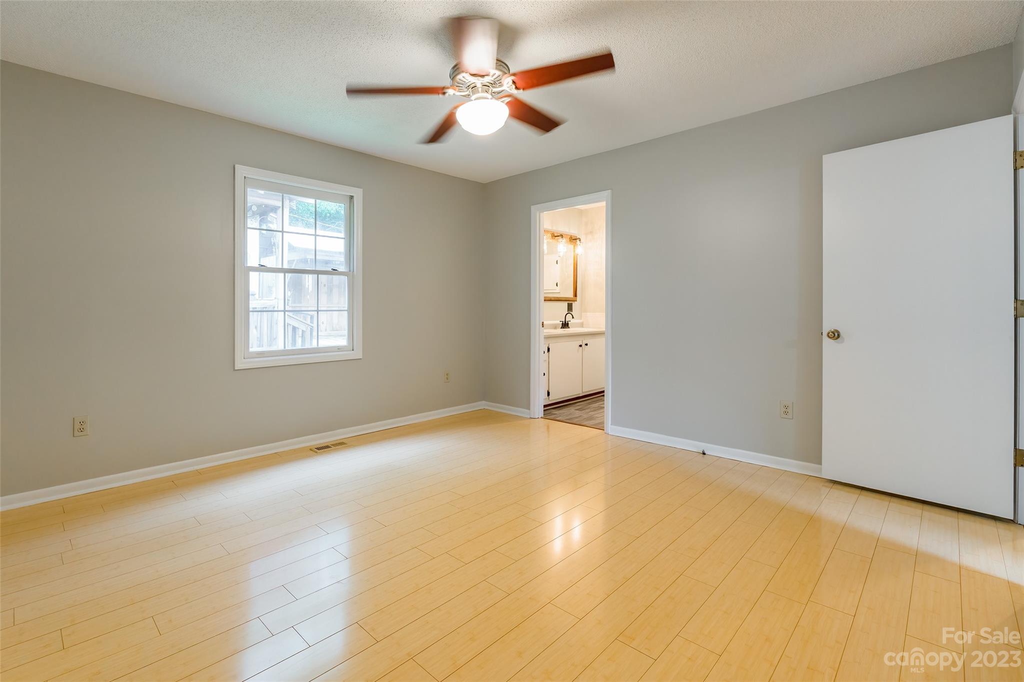 74 Joe Miller Road Jefferson, SC 29718 - Photo 13 of 29 a view of an empty room with chandelier fan and a window