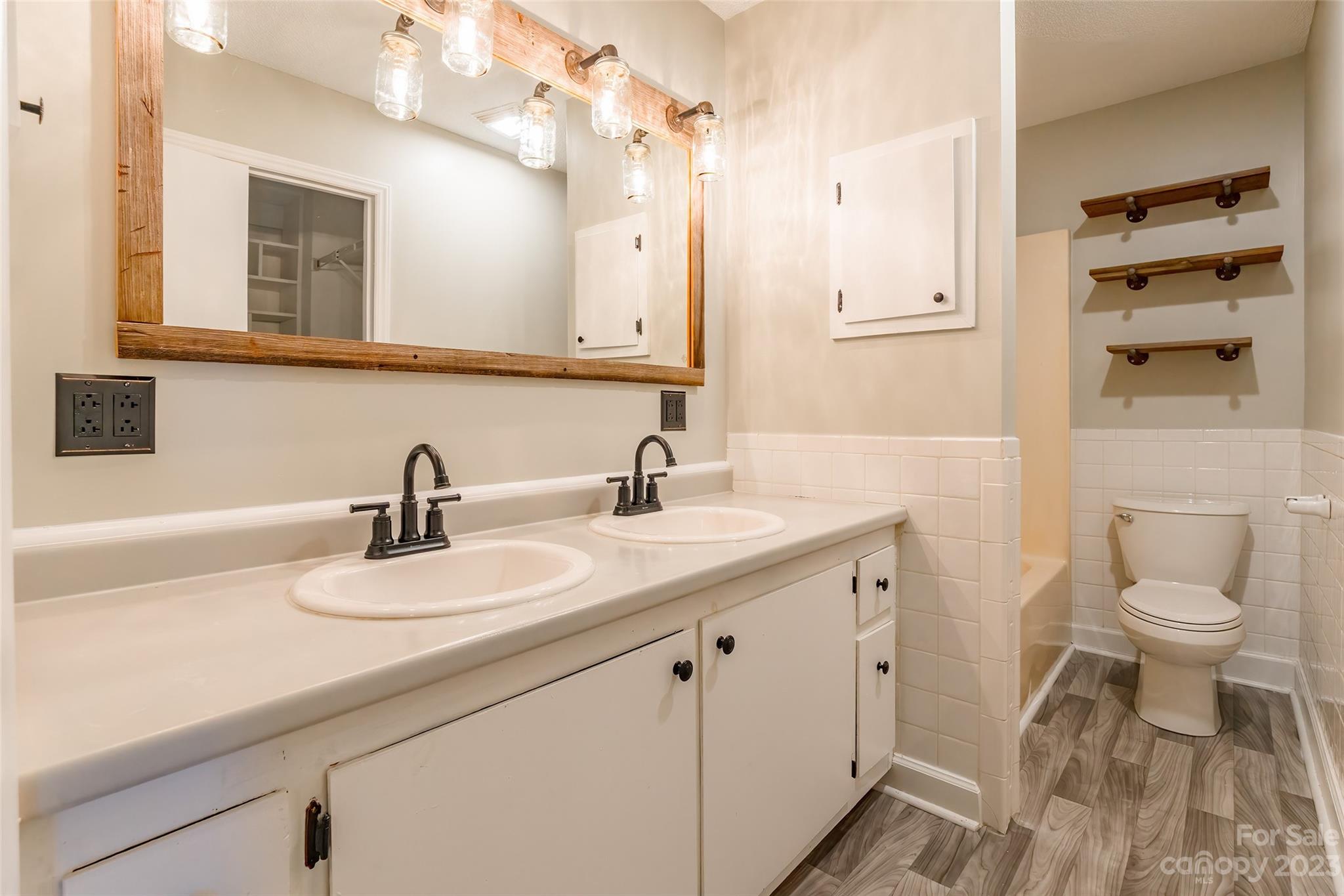 74 Joe Miller Road Jefferson, SC 29718 - Photo 14 of 29 a bathroom with a sink a toilet and a mirror