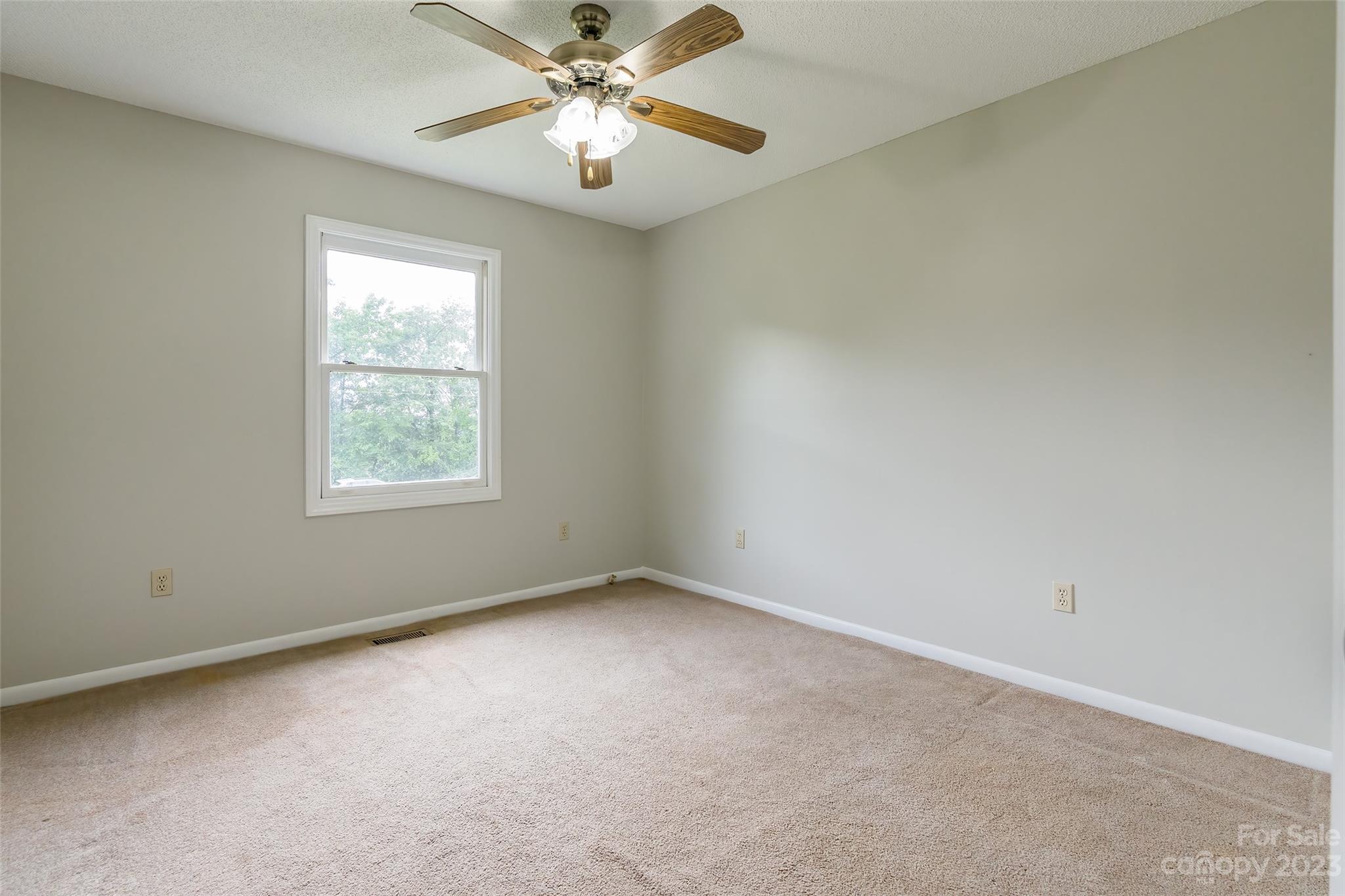 74 Joe Miller Road Jefferson, SC 29718 - Photo 15 of 29 an empty room with a window and a fan