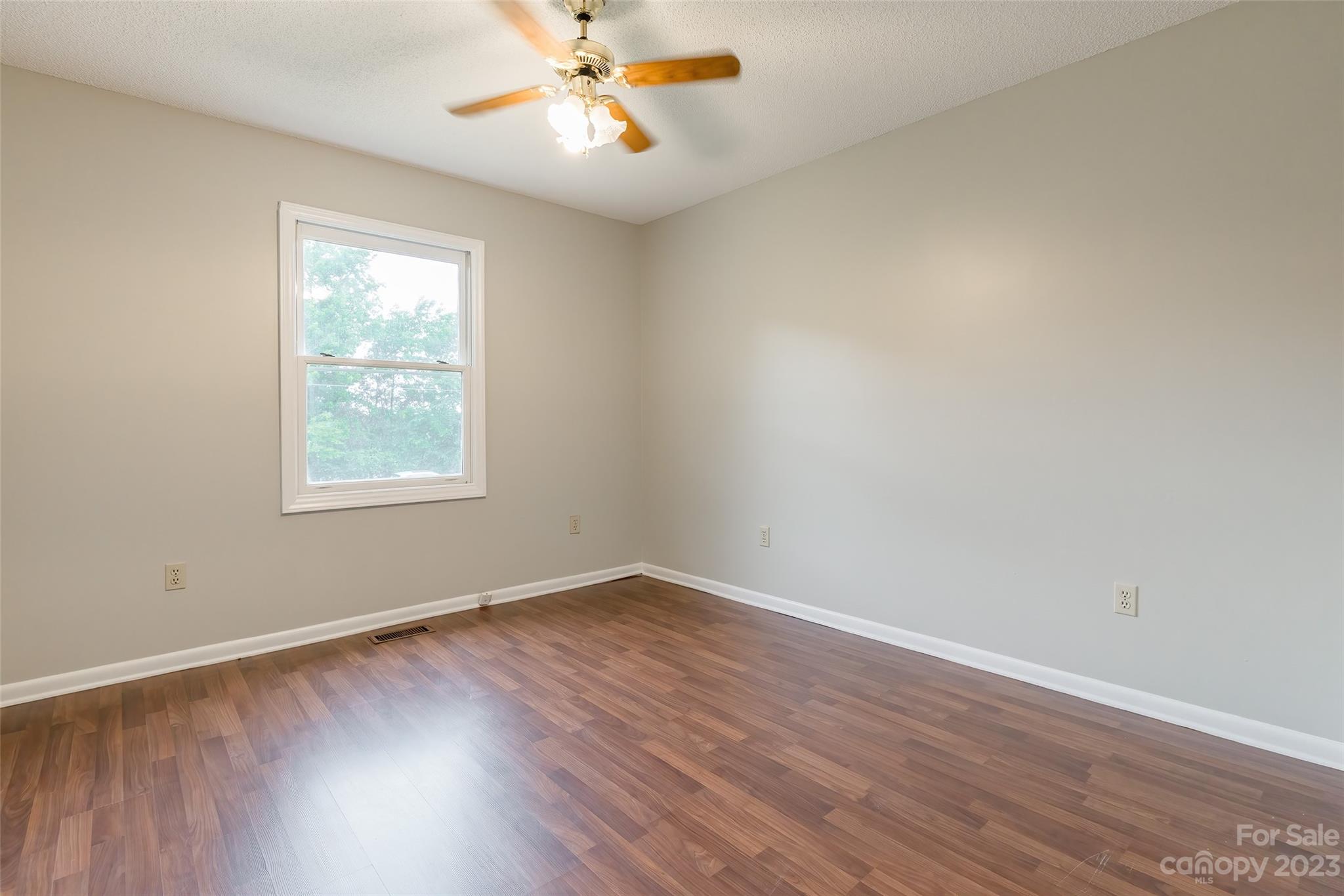 74 Joe Miller Road Jefferson, SC 29718 - Photo 17 of 29 a view of an empty room with wooden floor and a window