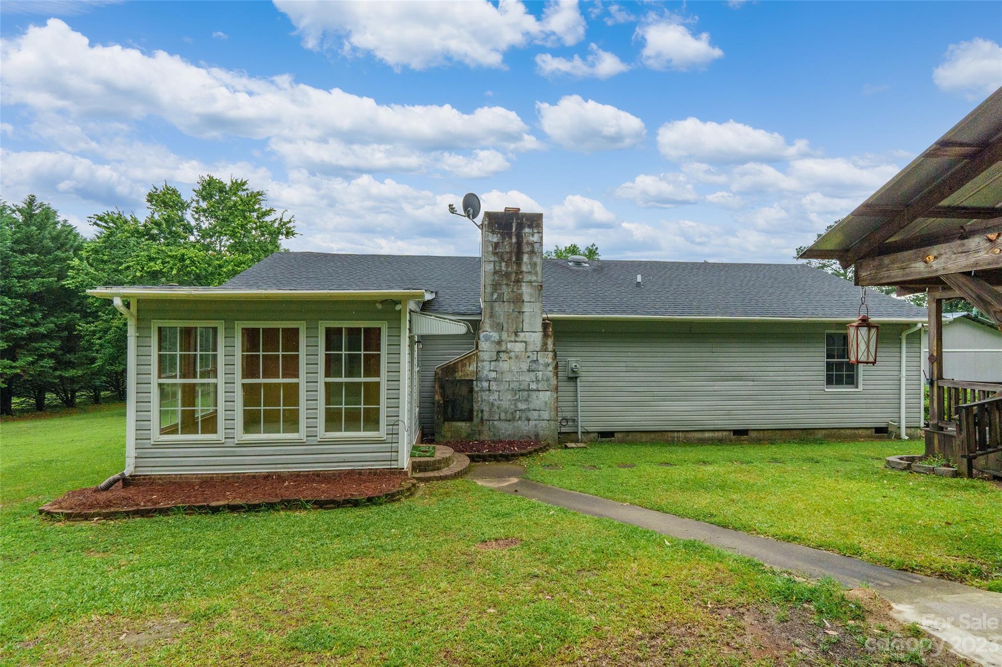 74 Joe Miller Road Jefferson, SC 29718 - Photo 22 of 29 a view of a house with a yard and a fireplace