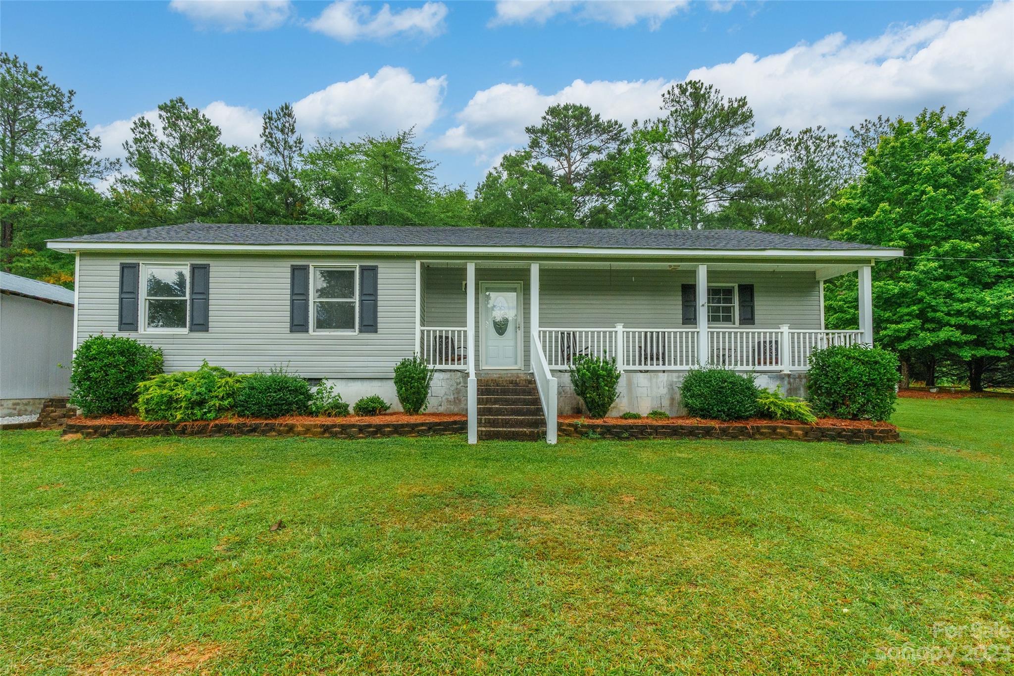 74 Joe Miller Road Jefferson, SC 29718 - Photo 3 of 29 a view of a house with a yard and potted plants