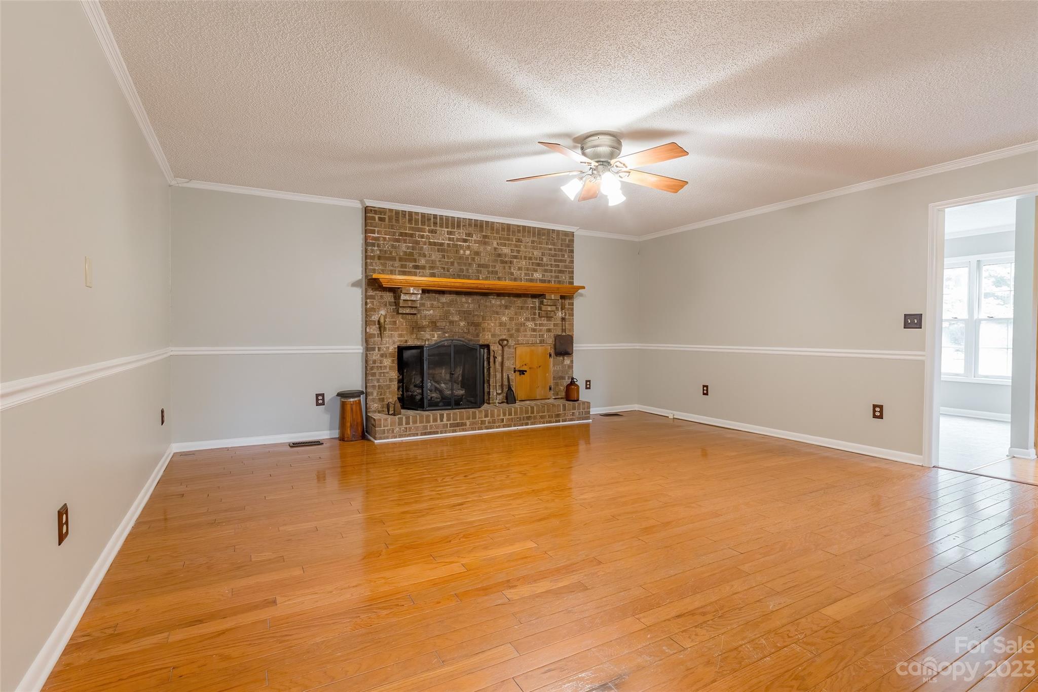 74 Joe Miller Road Jefferson, SC 29718 - Photo 5 of 29 a view of empty room with a fireplace and fan