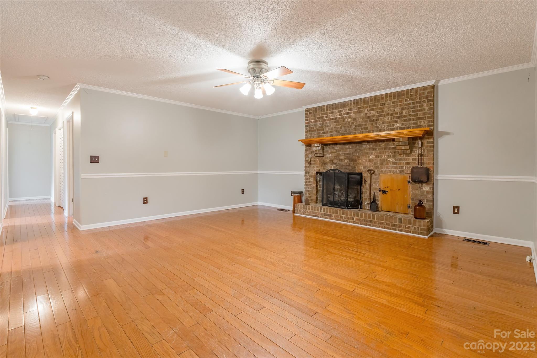 74 Joe Miller Road Jefferson, SC 29718 - Photo 6 of 29 a view of empty room with wooden floor and fireplace