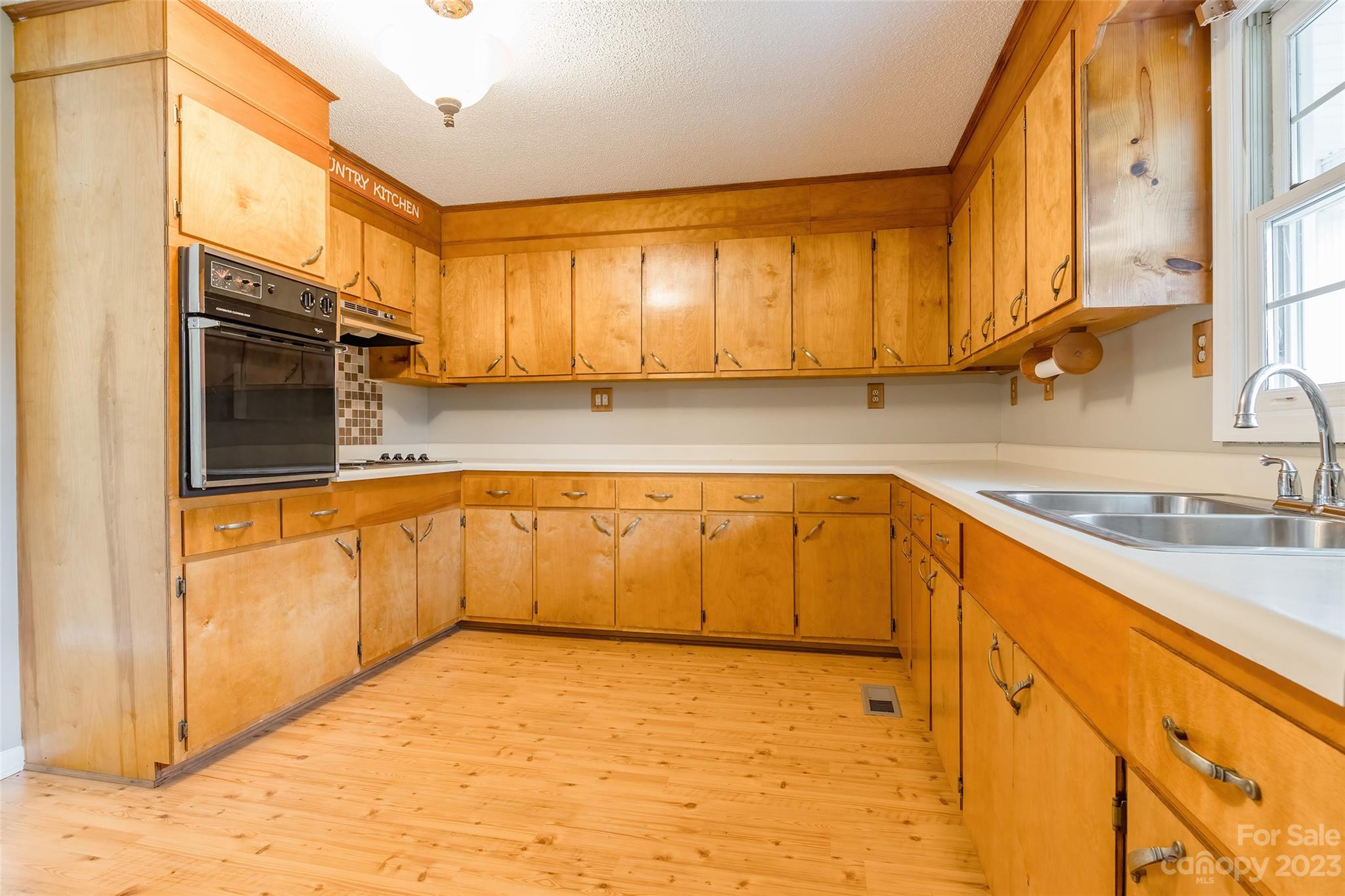 74 Joe Miller Road Jefferson, SC 29718 - Photo 8 of 29 a kitchen with stainless steel appliances granite countertop a sink and cabinets
