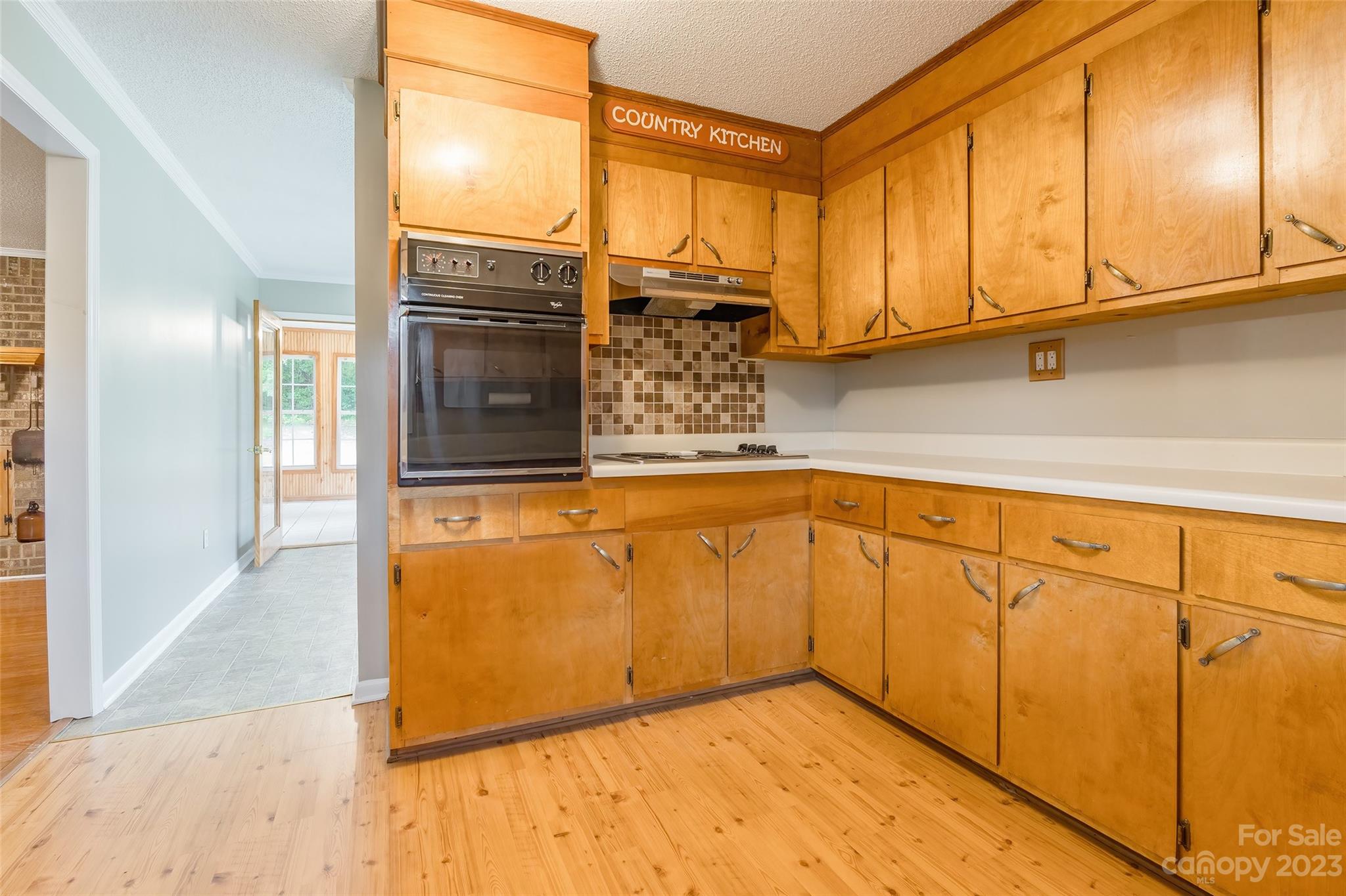 74 Joe Miller Road Jefferson, SC 29718 - Photo 10 of 29 a kitchen with stainless steel appliances granite countertop a refrigerator a stove and white cabinets with wooden floor