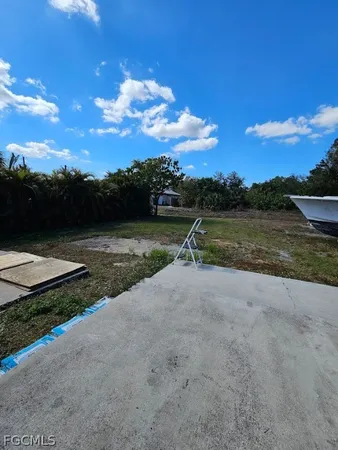 a view of a house with a yard and sitting area
