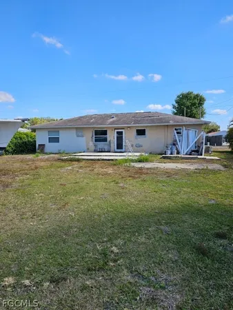 a view of a house with a yard and sitting area