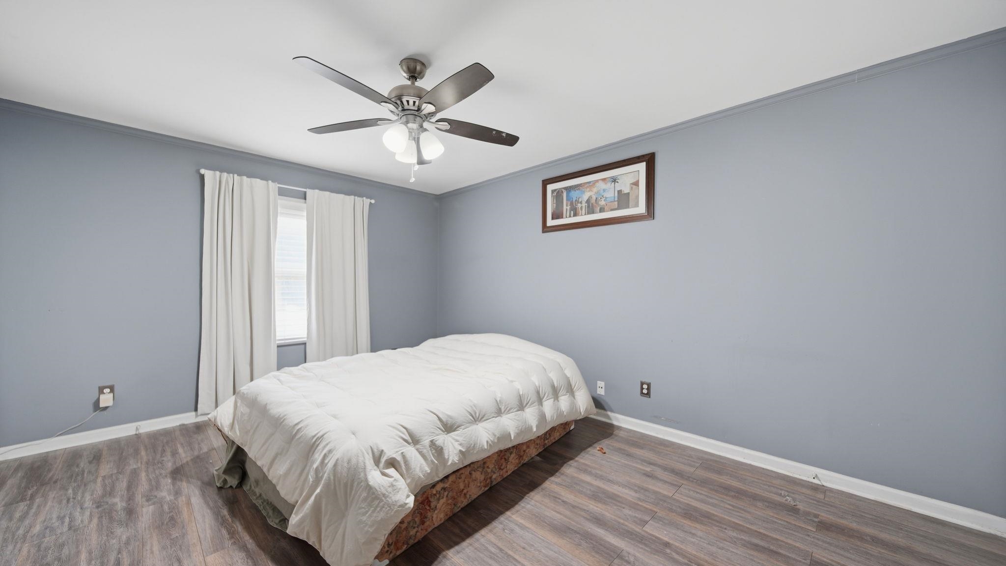 5866 Roxbury Drive, Unit 5866 Memphis, TN 38119 - Photo 13 of 20 Bedroom featuring wood-finish flooring, a ceiling fan with integrated lighting, and a window with white blinds and curtains