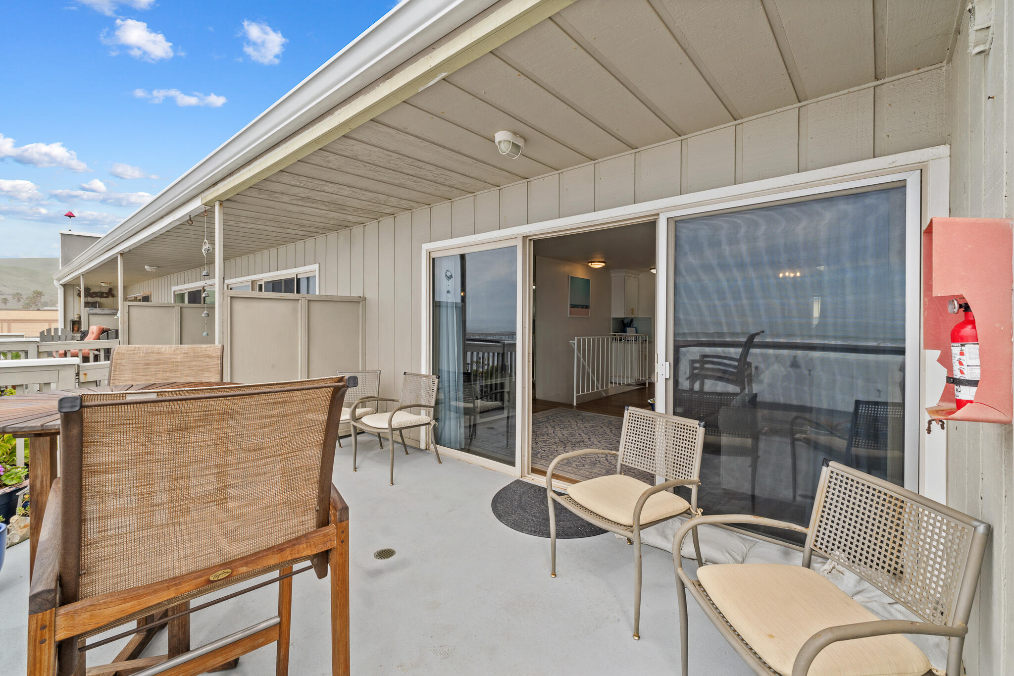 77 North Ocean Avenue, Unit 12 Cayucos, CA 93430 - Photo 33 of 41 a balcony with table and chairs