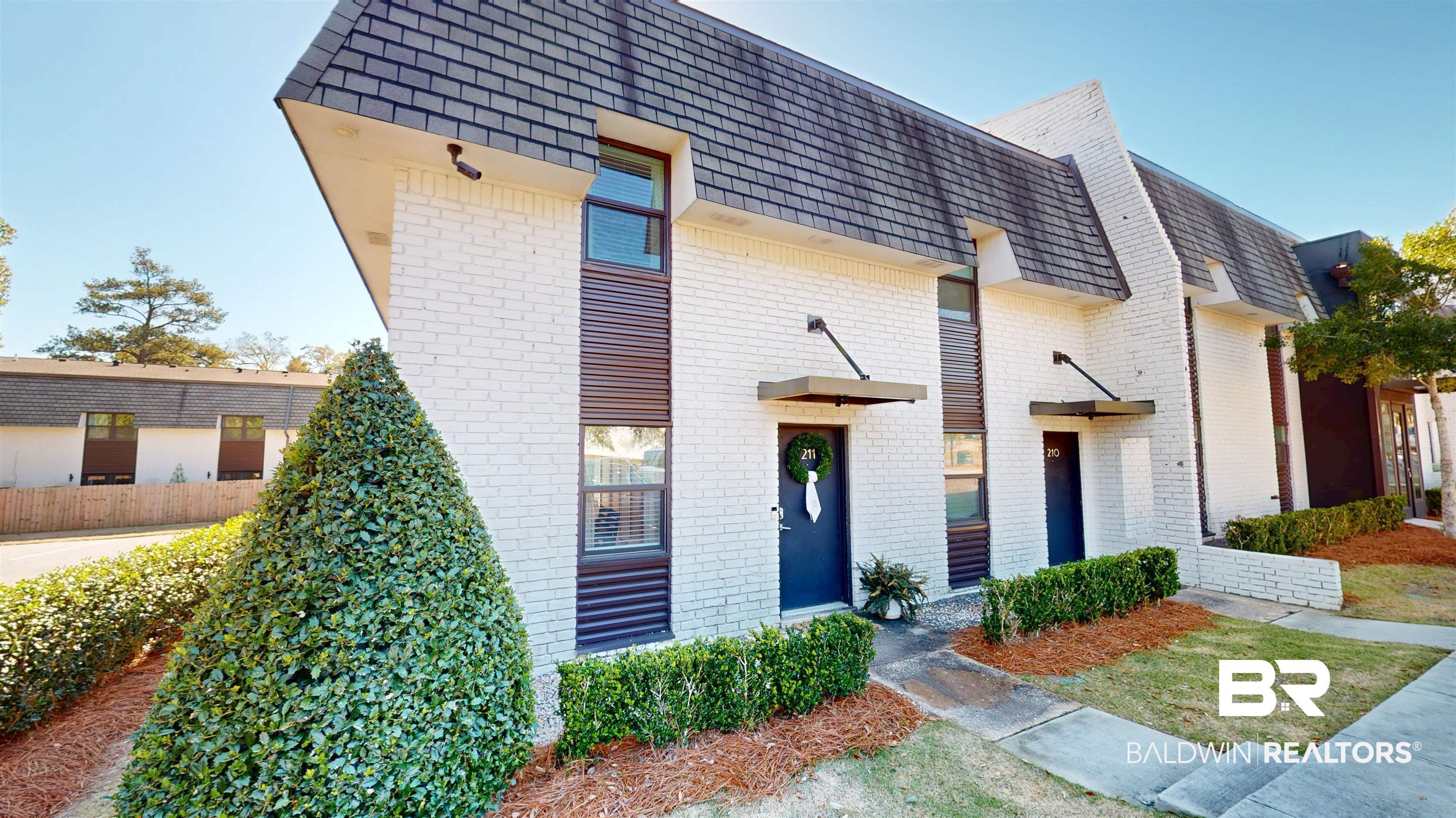 3655 Old Shell Road, Unit 211 Mobile, AL 36608 - Photo 1 of 17 Contemporary home featuring mansard roof, brick siding, and a shingled roof