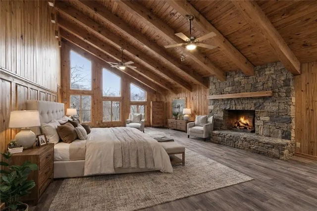 a spacious bedroom with a bed and a fireplace