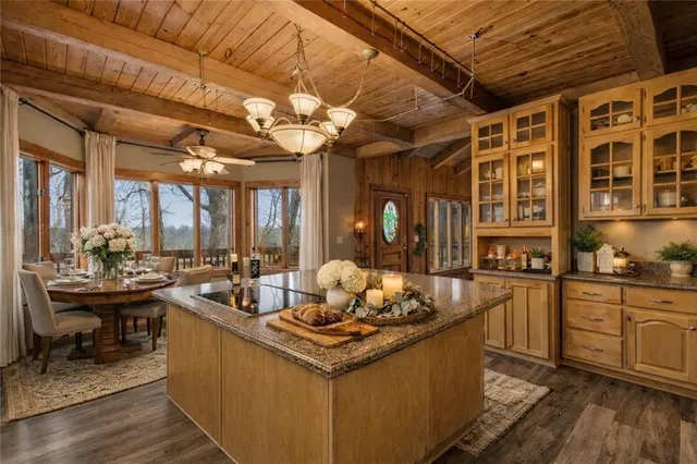 a kitchen with a stove a sink dishwasher and a stove with wooden floor