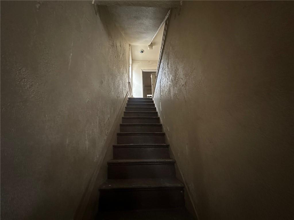 702 Whitney Avenue Pittsburgh, PA 15221 - Photo 14 of 39 a view of a hallway with stairs