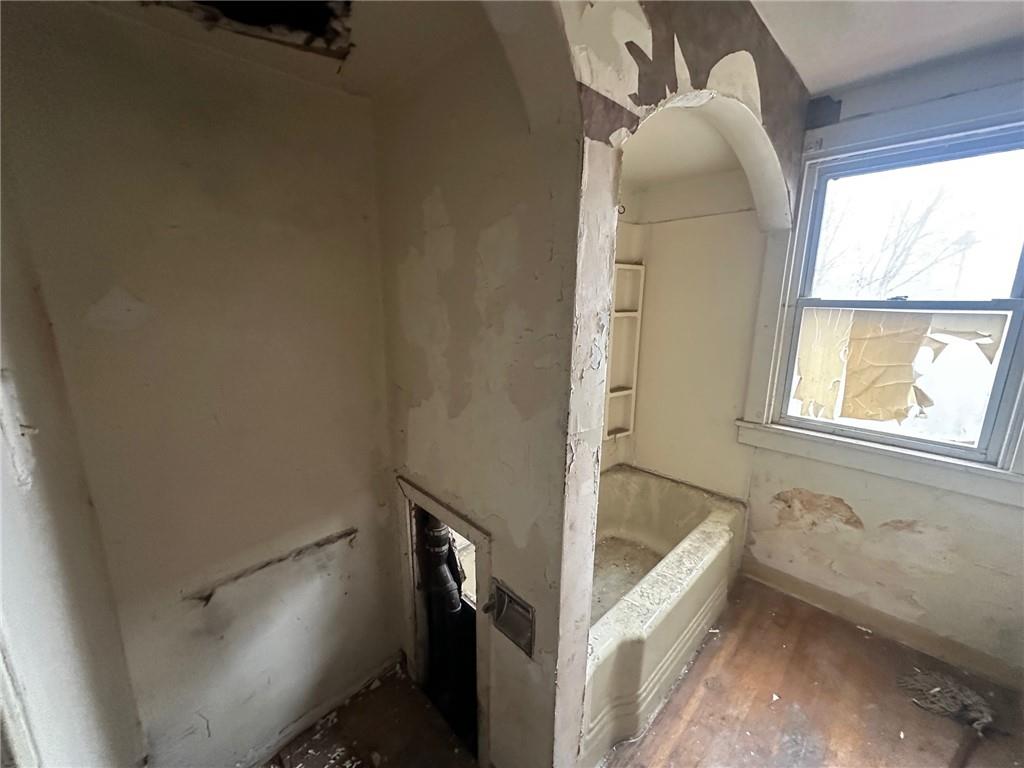 702 Whitney Avenue Pittsburgh, PA 15221 - Photo 15 of 39 a bathroom with a tub sink and window
