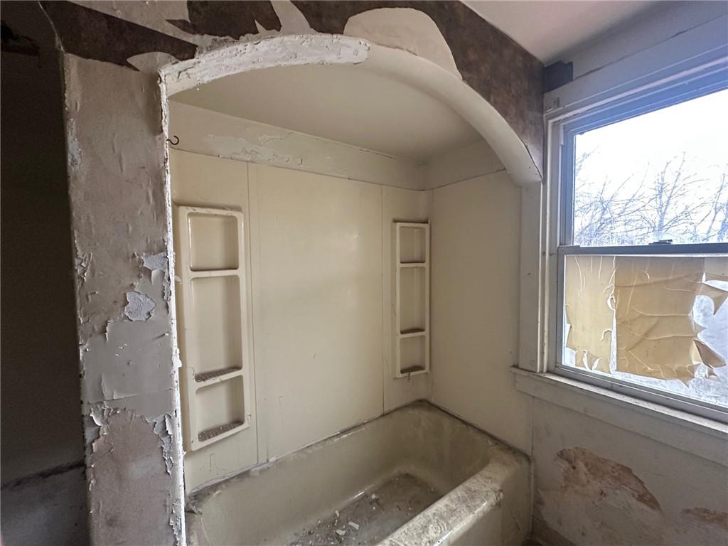 702 Whitney Avenue Pittsburgh, PA 15221 - Photo 16 of 39 a bathroom with a tub and a window
