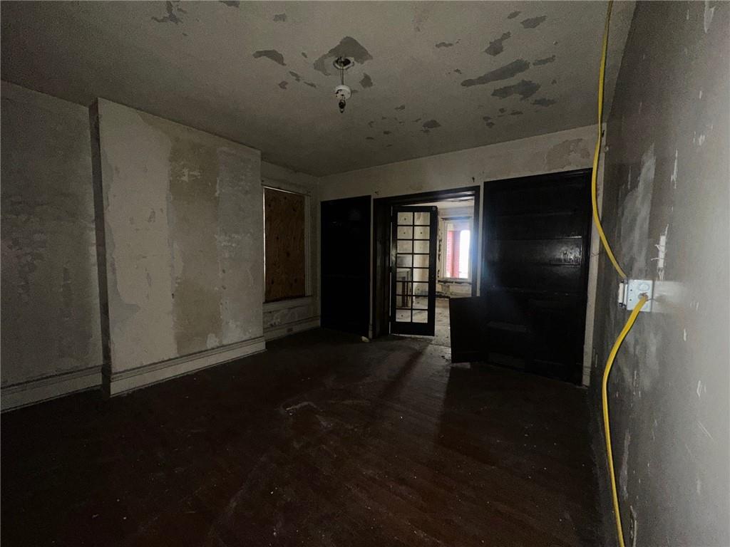 702 Whitney Avenue Pittsburgh, PA 15221 - Photo 21 of 39 a view of empty room with wooden floor and fan