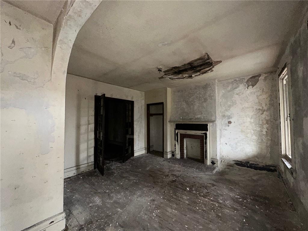 702 Whitney Avenue Pittsburgh, PA 15221 - Photo 24 of 39 an empty room with windows and a fireplace