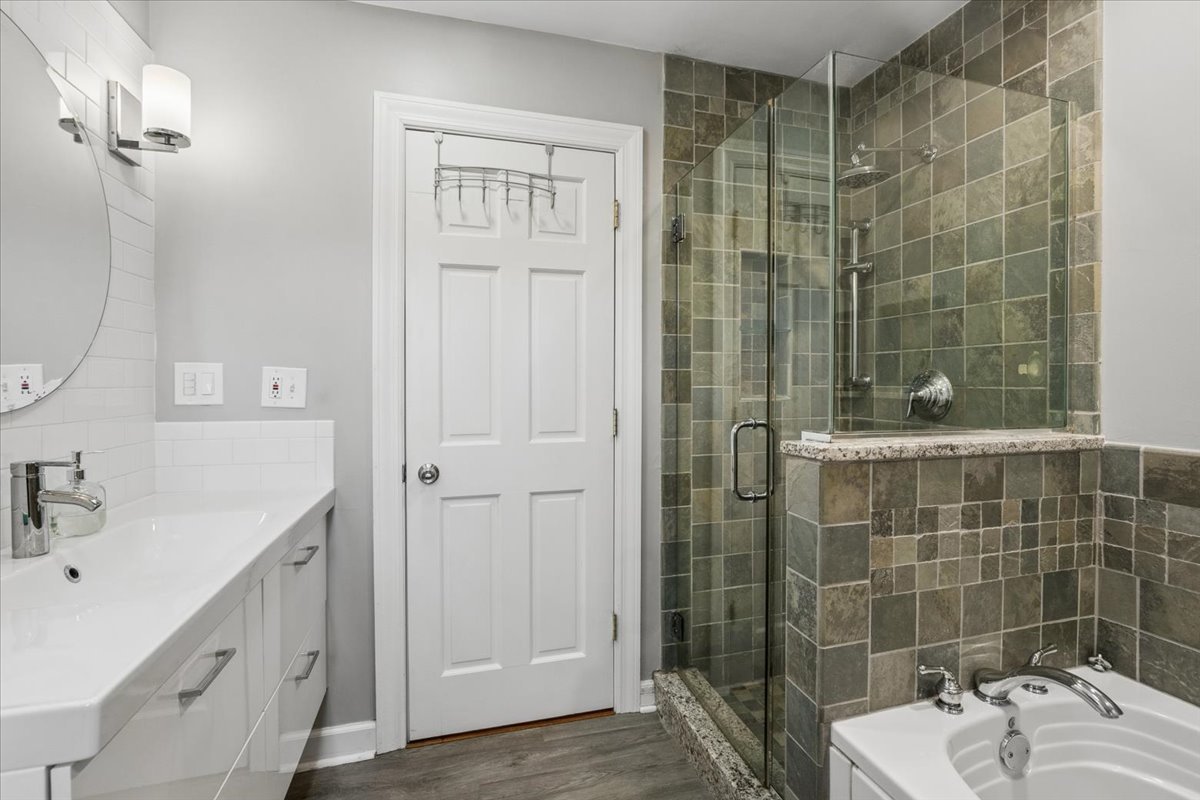 904 West Woodland Road Lake Bluff, IL 60044 - Photo 14 of 28 a bathroom with a sink shower and a mirror