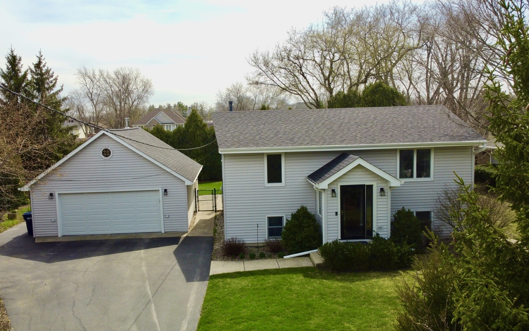 904 West Woodland Road Lake Bluff, IL 60044 - Photo 22 of 28 a front view of a house with a yard and trees