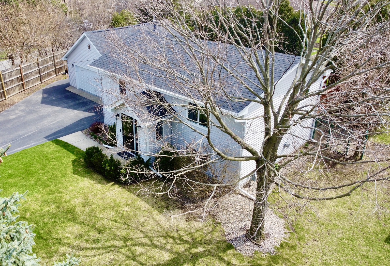 904 West Woodland Road Lake Bluff, IL 60044 - Photo 23 of 28 a view of a backyard with table and chairs with wooden fence
