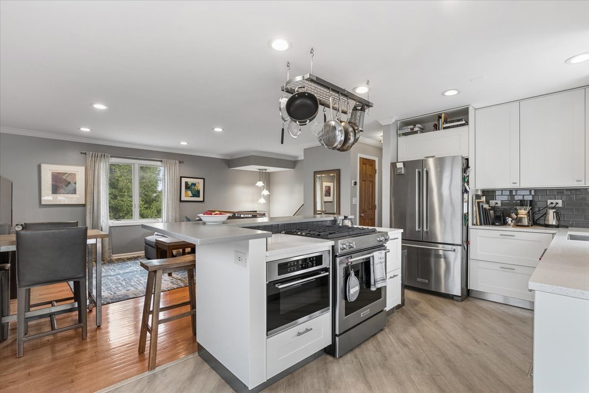 904 West Woodland Road Lake Bluff, IL 60044 - Photo 5 of 28 a kitchen with stainless steel appliances granite countertop a stove and a refrigerator