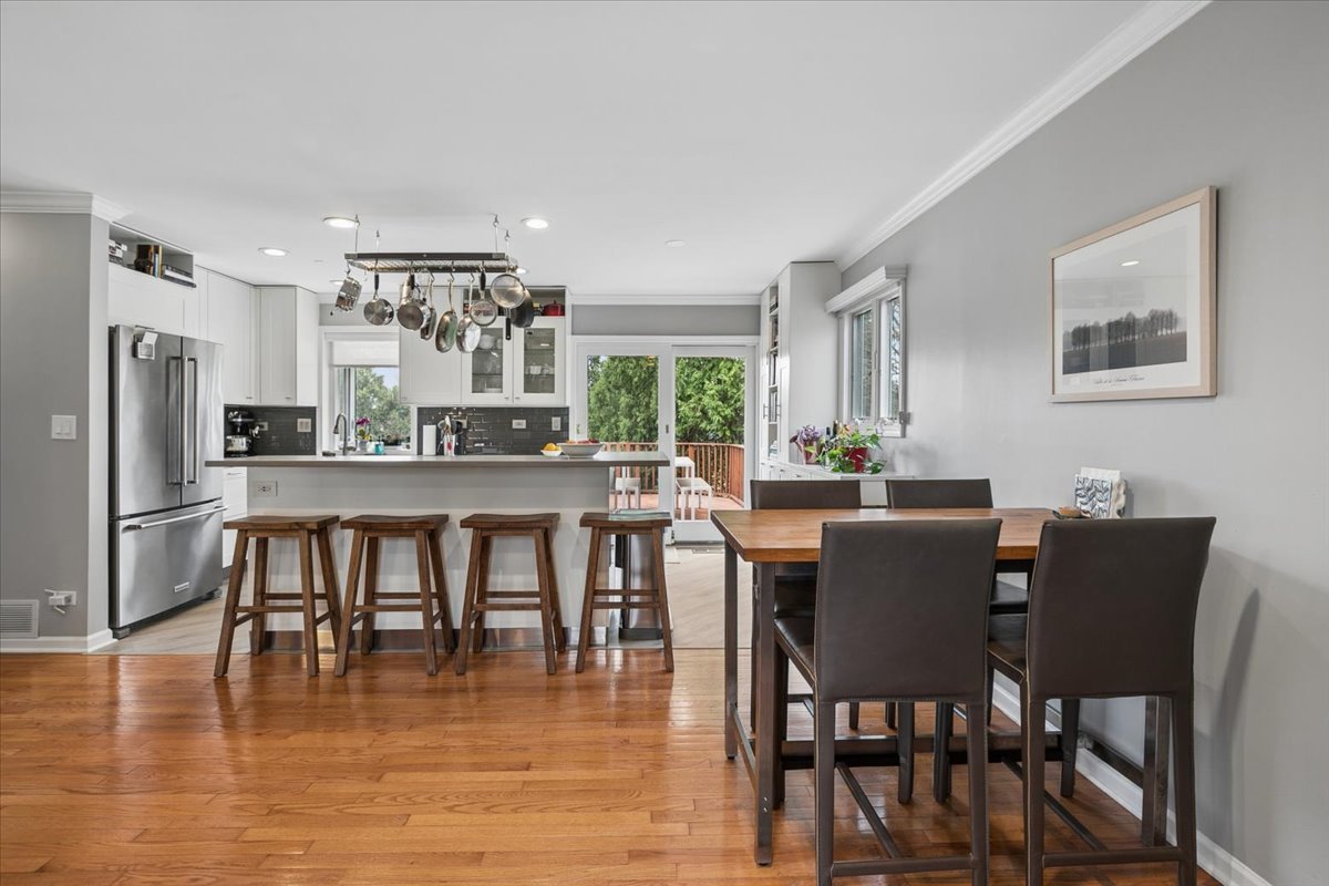 904 West Woodland Road Lake Bluff, IL 60044 - Photo 9 of 28 a dining room with furniture and wooden floor
