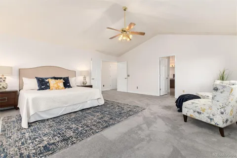 a bedroom with a bed and ceiling fan