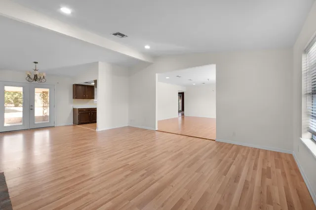 a view of empty room with wooden floor and fireplace