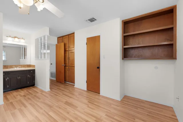 a view of an empty room with a kitchen