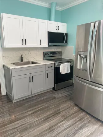 a utility room with sink dryer and washer