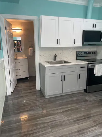 a view of kitchen and wooden floor