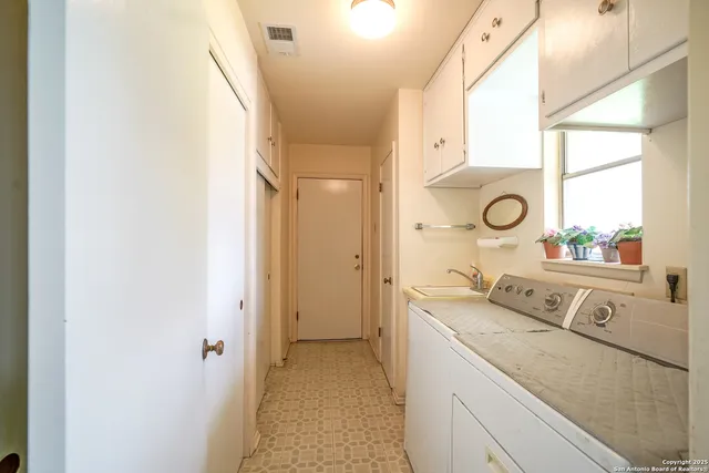 a bathroom with a granite countertop sink mirror vanity and a window