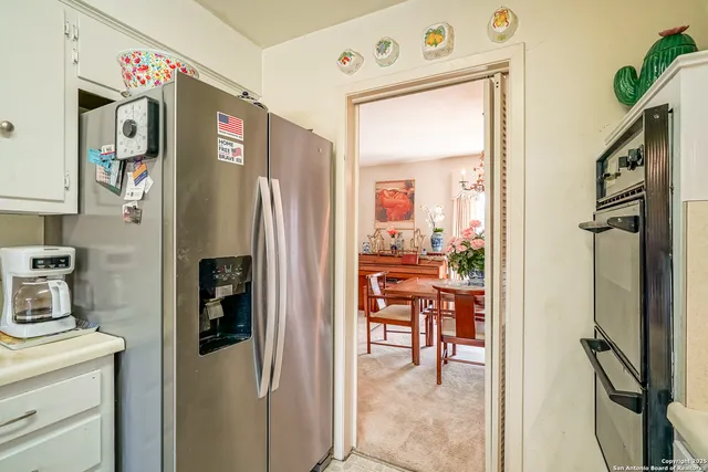 a kitchen with stainless steel appliances granite countertop a refrigerator and a stove