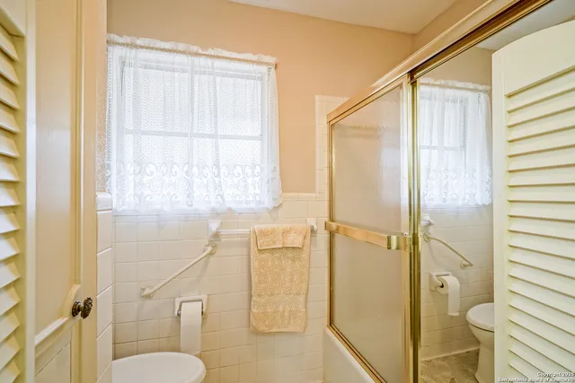 a bathroom with a shower and toilet