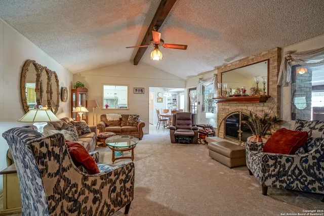 a living room with furniture fireplace and window