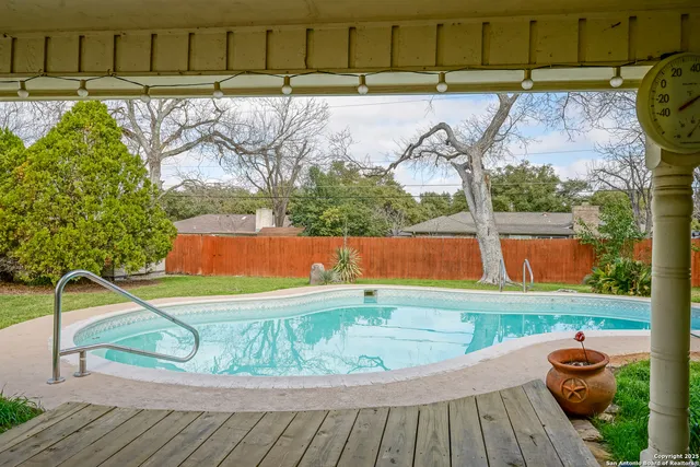 a view of a swimming pool with a yard