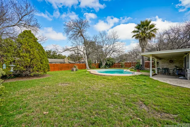 a view of house with outdoor space and swimming pool