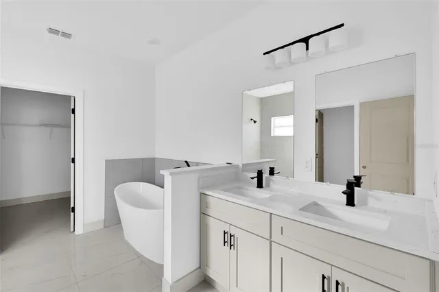 a bathroom with a double vanity sink and mirror