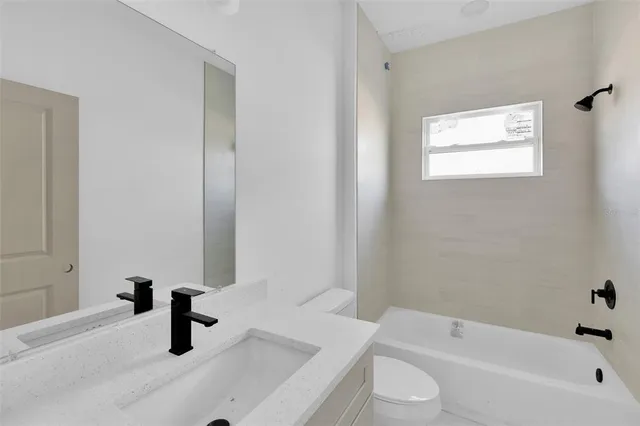 a bathroom with a sink a toilet and a bathtub