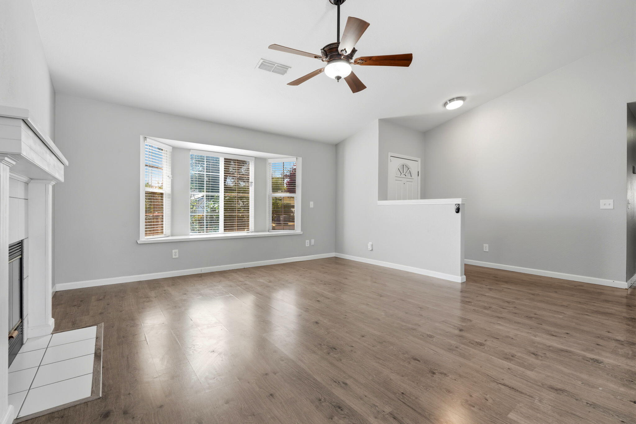 481 Katelyn Court Exeter, CA 93221 - Photo 9 of 33 a view of an empty room with wooden floor and a window