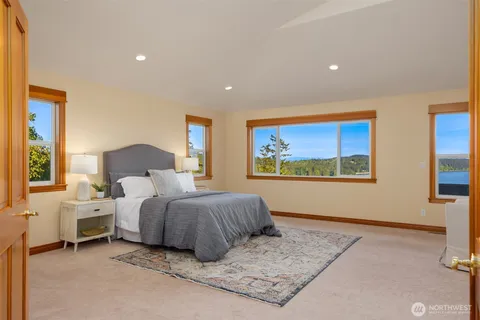 a spacious bedroom with a large bed and a couch