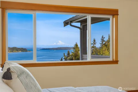 a spacious bathroom with a double vanity sink a large mirror and a shower