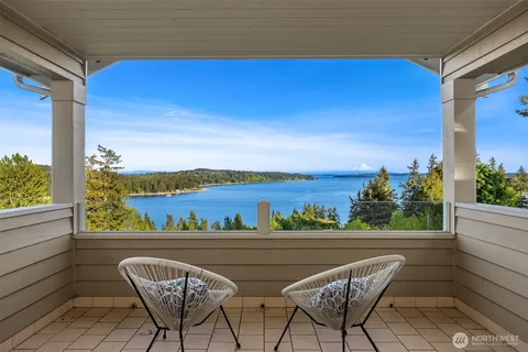 a work room with furniture a rug and a window
