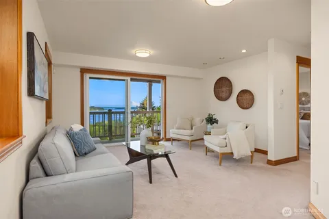 a view of a balcony with chairs and wooden floor