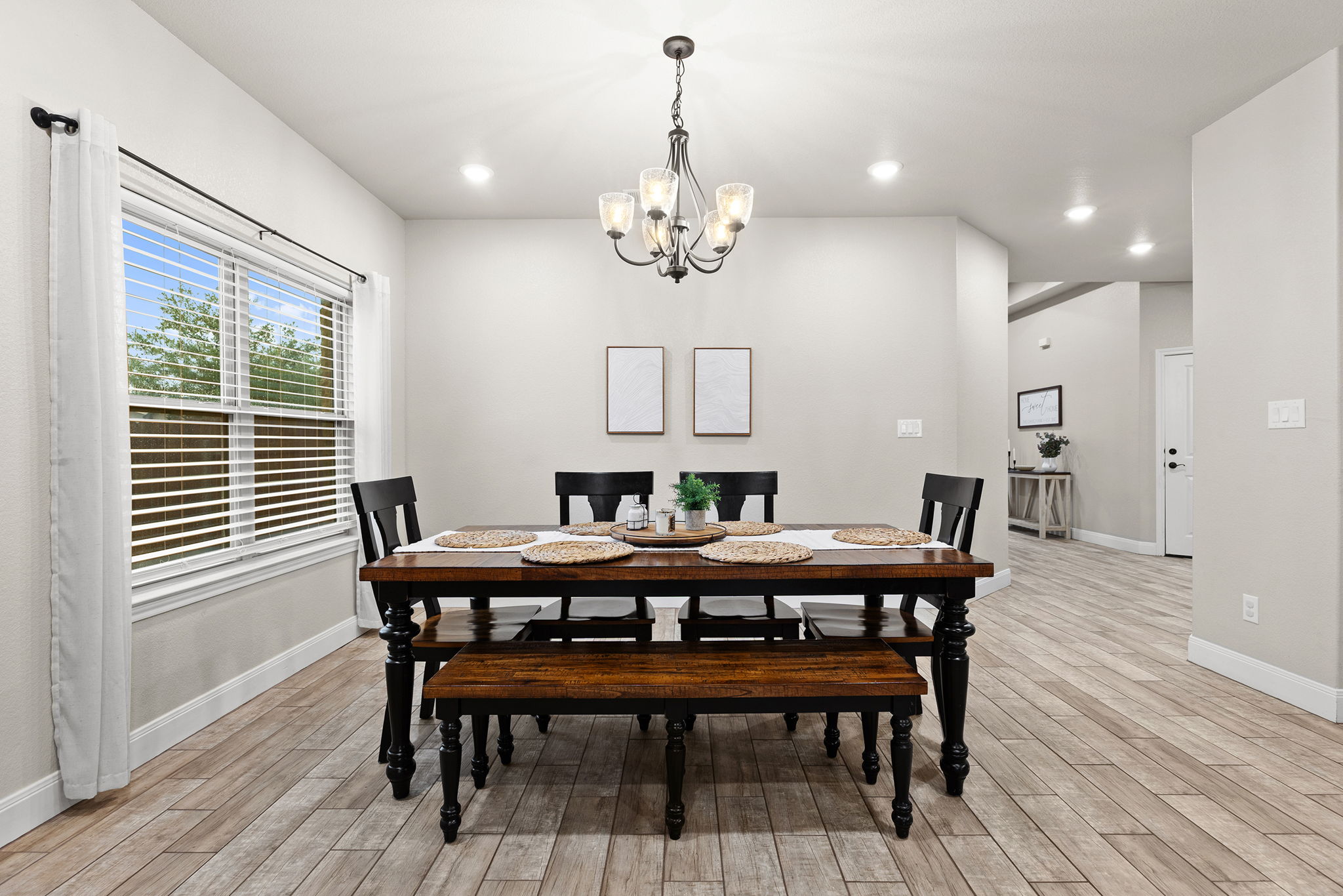 161 Greg Lane Jarrell, TX 76537 - Photo 16 of 35 Dining area featuring wood-finish flooring, a window with blinds, recessed lighting, and a decorative chandelier