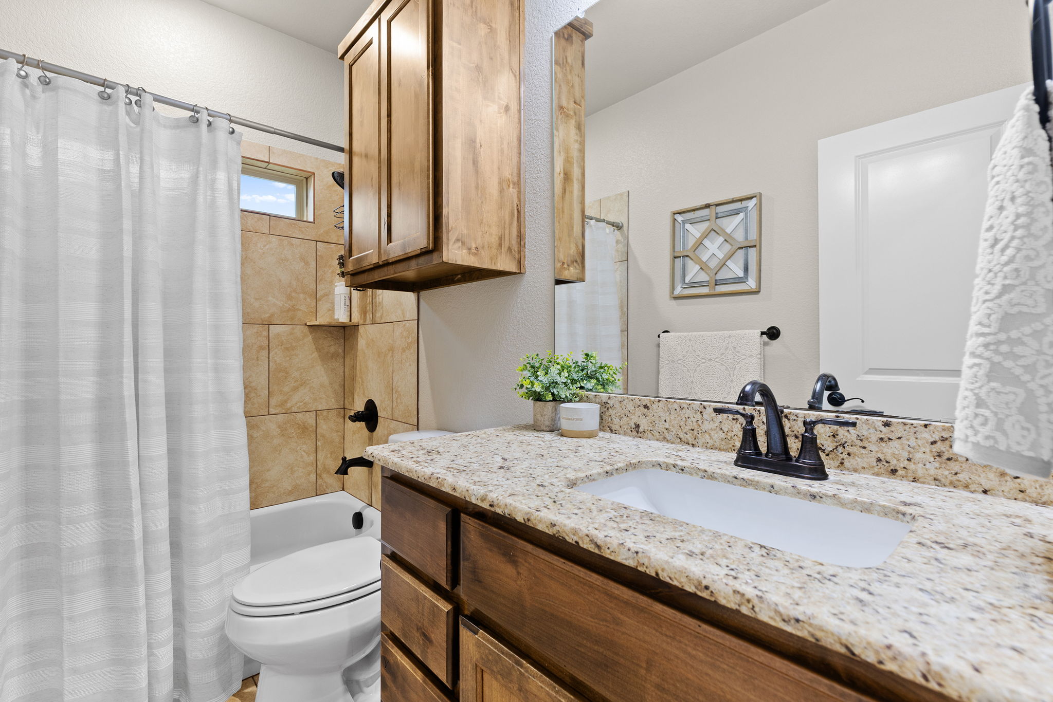 161 Greg Lane Jarrell, TX 76537 - Photo 22 of 35 Bathroom vanity featuring a light granite countertop with an undermount sink and dark bronze faucet